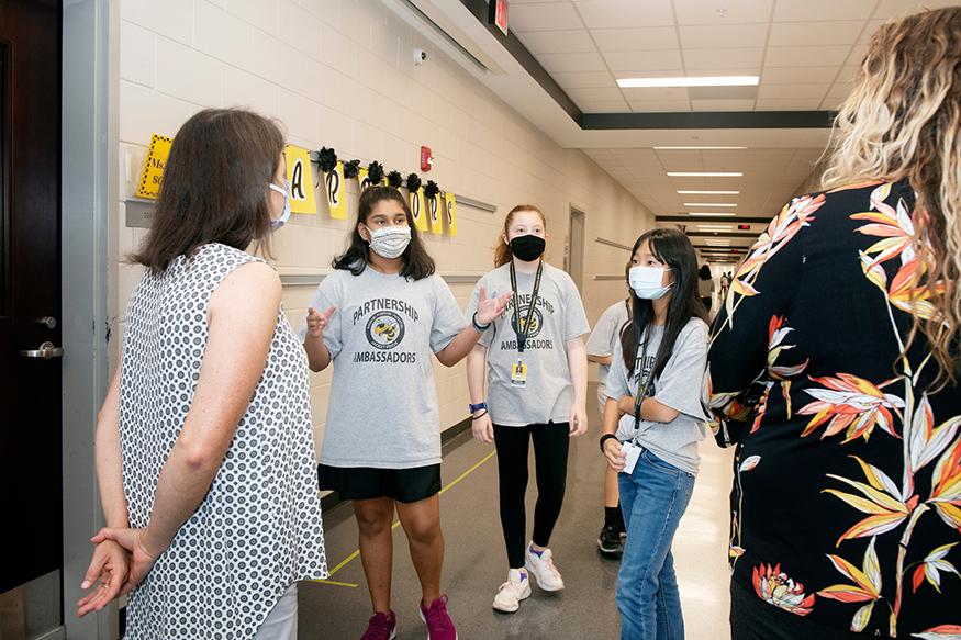 Partnership Ambassadors giving a tour in school hallway